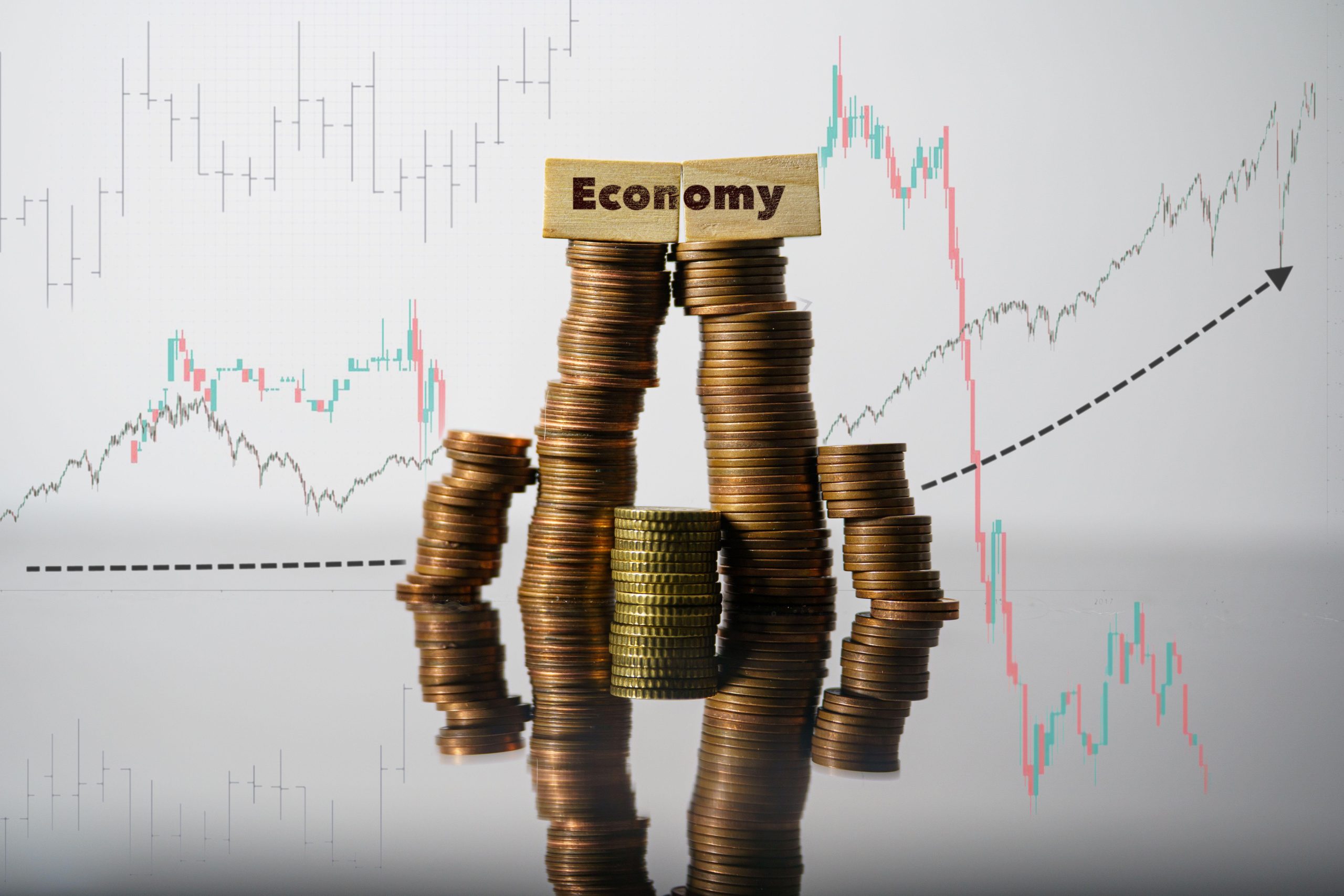 2PN6AEE Economy concept. Economy word written on wooden bricks on stack coins