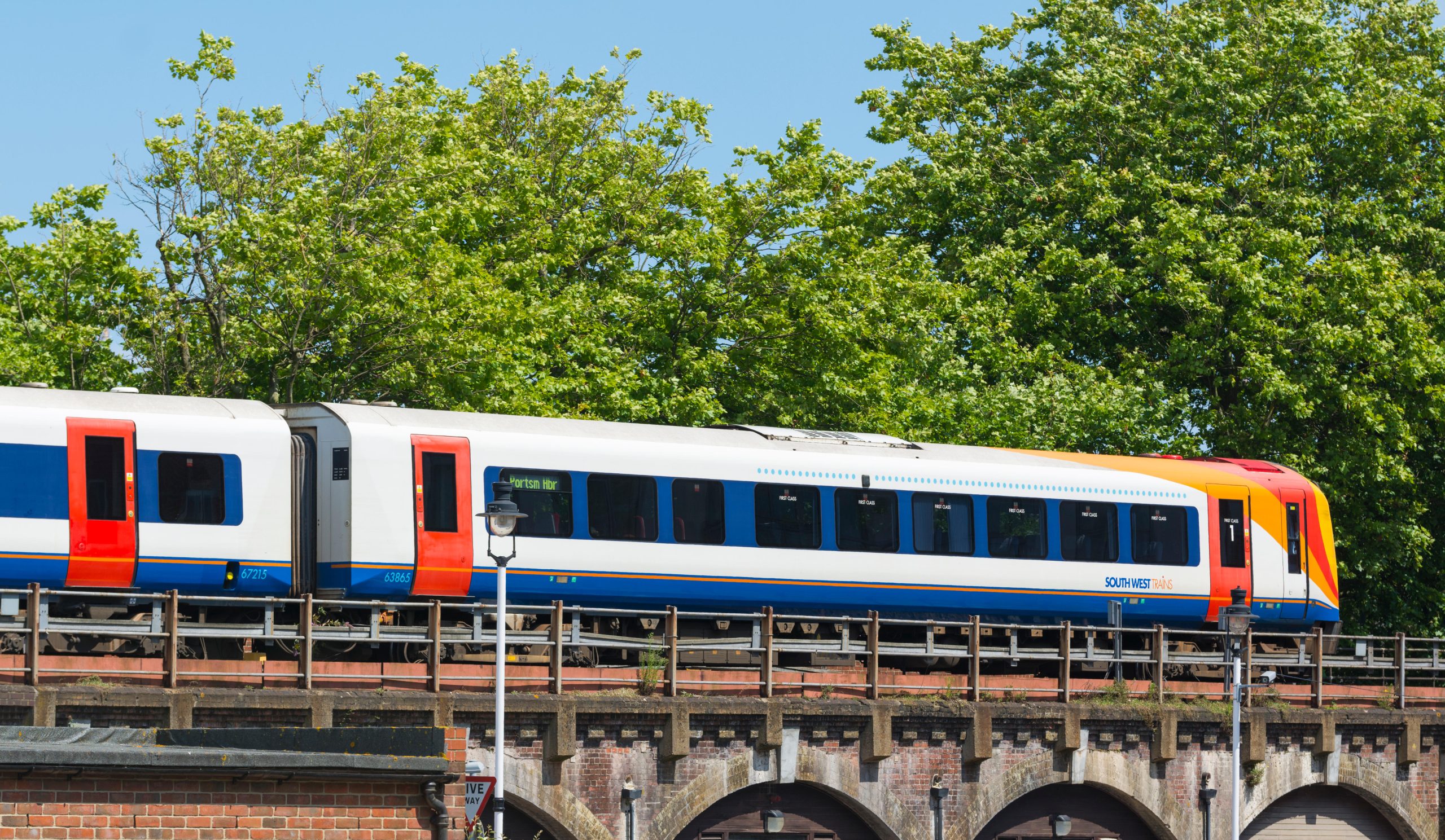 JHYHHC South West Train travelling over a bridge in Hampshire, England, UK.